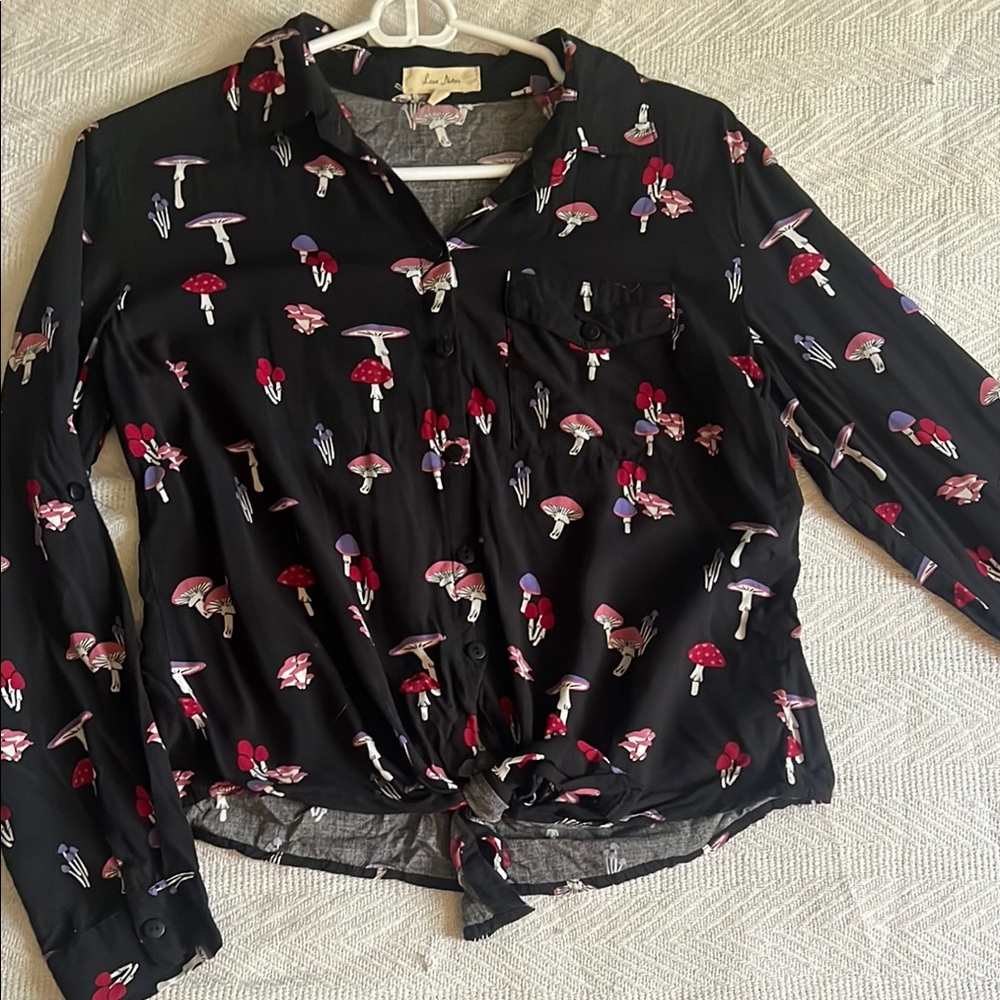 Love Notes mushroom long sleeve collared bottom wrap top.